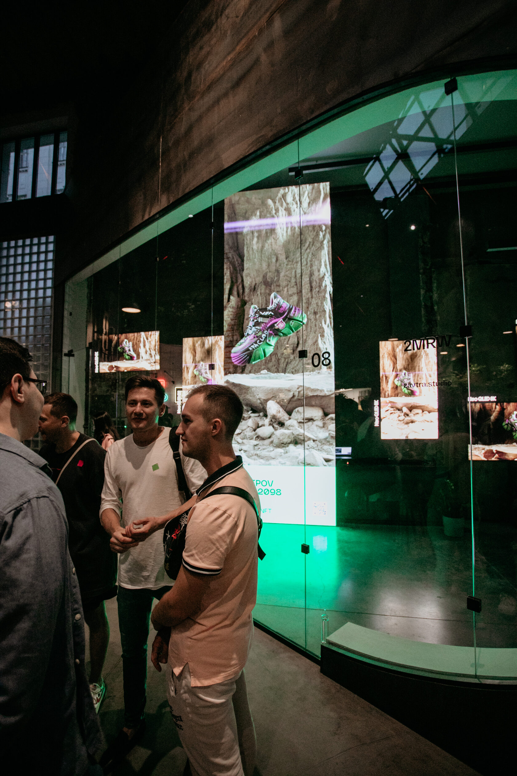 Visitors at the Digital Sneakers exhibition screens at Supermetall