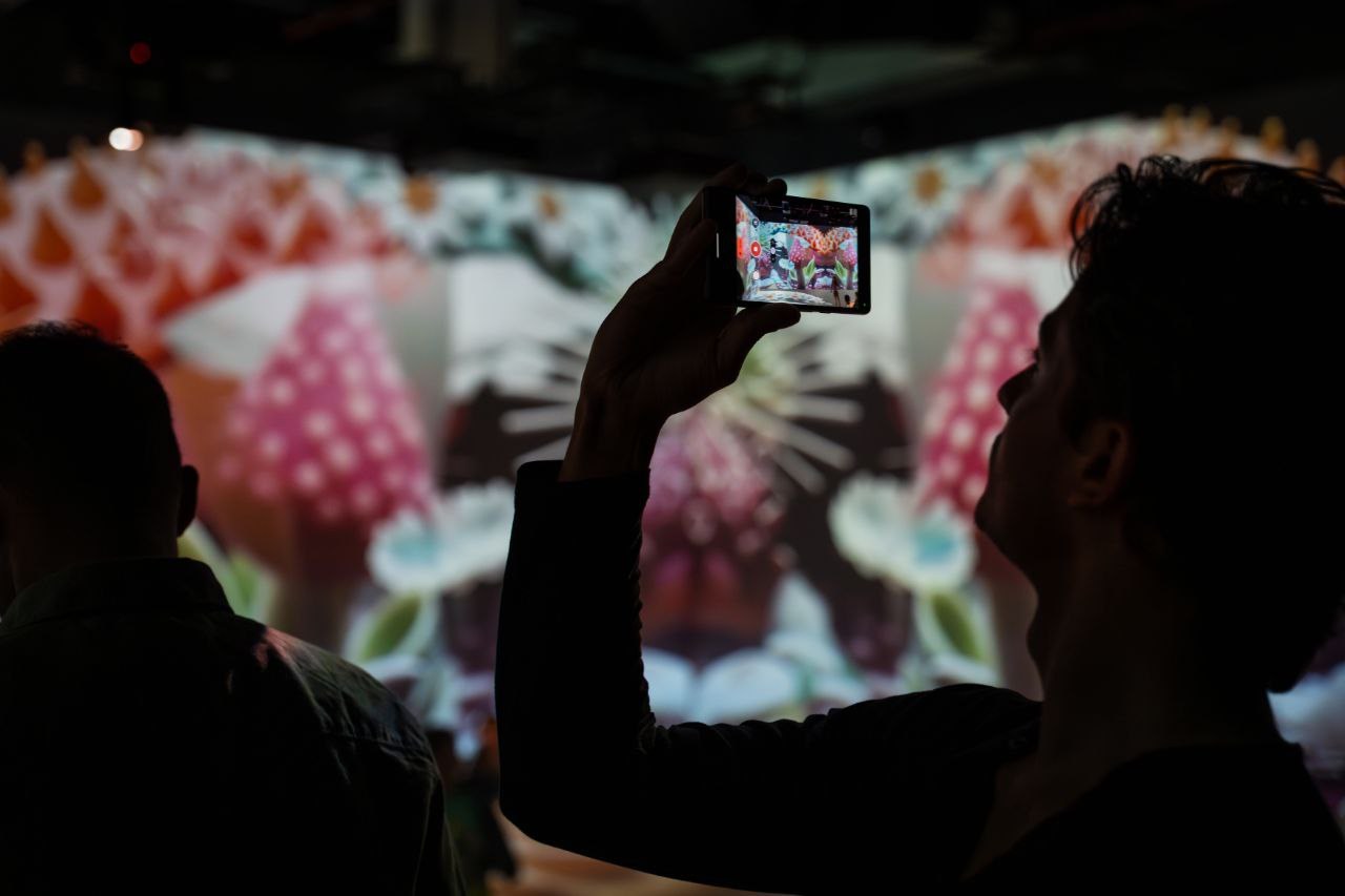 Visitors inside a projected digital-art installation.